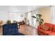 Living room with hardwood floors, comfortable seating, and potted plants at 122 Magnolia Dr, Winter Haven, FL 33881