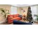 Living room with hardwood floors, a sofa, and a Christmas tree at 122 Magnolia Dr, Winter Haven, FL 33881