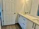 Modern bathroom with double vanity and wood-look floors at 1304 Hillsborough Ct, Kissimmee, FL 34759