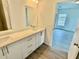 Bathroom with double vanity and access to bedroom and additional room at 1304 Hillsborough Ct, Kissimmee, FL 34759