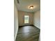 Spacious bedroom with a window and wood-look floors at 1304 Hillsborough Ct, Kissimmee, FL 34759