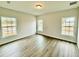 Well-lit bedroom with vinyl flooring and large windows at 1304 Hillsborough Ct, Kissimmee, FL 34759