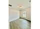 Bright bedroom with window and wood-look floors at 1304 Hillsborough Ct, Kissimmee, FL 34759