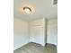 Bright bedroom with double door closet and wood-look floors at 1304 Hillsborough Ct, Kissimmee, FL 34759