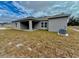 Rear view of single story house and backyard at 1304 Hillsborough Ct, Kissimmee, FL 34759