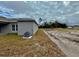 Side view of single-story house and yard at 1304 Hillsborough Ct, Kissimmee, FL 34759