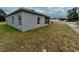 Rear view of single-story house with gray siding at 1304 Hillsborough Ct, Kissimmee, FL 34759