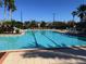 Community swimming pool with lounge chairs at 1351 Venezia Ct # 304, Davenport, FL 33896