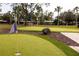 Artificial putting green with flags and a bench at 1351 Venezia Ct # 304, Davenport, FL 33896