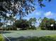 Outdoor basketball court surrounded by trees at 142 Winghurst Blvd, Orlando, FL 32828