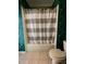 Clean bathroom with tub and shower, and updated striped shower curtain at 142 Winghurst Blvd, Orlando, FL 32828