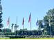 Eastwood entrance sign with flags, lush landscaping, and palm trees at 142 Winghurst Blvd, Orlando, FL 32828