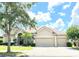 Spacious tan house with three-car garage at 142 Winghurst Blvd, Orlando, FL 32828