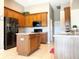 Kitchen features wood cabinets, stainless steel appliances, and an island at 142 Winghurst Blvd, Orlando, FL 32828