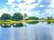 Peaceful lake view with tranquil reflection of clouds at 142 Winghurst Blvd, Orlando, FL 32828