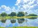 Stunning lake view with clouds reflecting on water at 142 Winghurst Blvd, Orlando, FL 32828