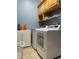 Laundry room with washer, dryer, and ample shelving at 142 Winghurst Blvd, Orlando, FL 32828