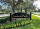 Freedom Park sign with landscaping and road view at 142 Winghurst Blvd, Orlando, FL 32828