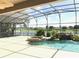 Screened-in pool and spa with a view of the golf course and lake at 142 Winghurst Blvd, Orlando, FL 32828