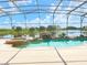 Inviting screened pool with spa and a scenic lake view at 142 Winghurst Blvd, Orlando, FL 32828