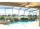 Enclosed pool and spa with a waterfall feature, overlooking a golf course at 142 Winghurst Blvd, Orlando, FL 32828