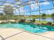 Inviting screened pool with spa and a scenic lake view at 142 Winghurst Blvd, Orlando, FL 32828