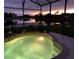 Night view of a lovely pool and spa with sunset in background at 142 Winghurst Blvd, Orlando, FL 32828