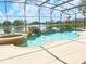 Inviting screened pool with spa and a scenic lake view at 142 Winghurst Blvd, Orlando, FL 32828