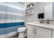 Modern bathroom with white cabinets and blue striped shower curtain at 1449 Ashdown Ct, Sanford, FL 32771