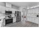 Modern kitchen with white cabinets, stainless steel appliances, and quartz countertops at 1449 Ashdown Ct, Sanford, FL 32771