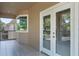 Screened balcony with French doors and tile flooring at 148 Calliope St, Ocoee, FL 34761