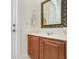 Bathroom with wood cabinets, marble countertop, and a large mirror at 148 Calliope St, Ocoee, FL 34761