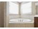 Bathroom featuring a corner soaking tub with tile surround at 148 Calliope St, Ocoee, FL 34761