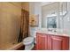 Bathroom with shower, toilet and wood vanity at 148 Calliope St, Ocoee, FL 34761