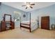 Light blue bedroom featuring a post bed and vintage dresser at 148 Calliope St, Ocoee, FL 34761