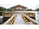 Wooden dock with gazebo overlooking a lake at 148 Calliope St, Ocoee, FL 34761