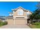 Two-story house with a three-car garage and manicured landscaping at 148 Calliope St, Ocoee, FL 34761