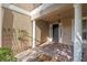 Elegant entryway with columns, a dark door, and brick flooring at 148 Calliope St, Ocoee, FL 34761