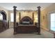 Luxurious Primary bedroom featuring a large four-poster bed at 148 Calliope St, Ocoee, FL 34761