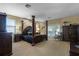 Primary bedroom with a large four-poster bed and ample space at 148 Calliope St, Ocoee, FL 34761