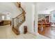 Grand staircase with wood railings and tile flooring, leading to the second floor at 148 Calliope St, Ocoee, FL 34761