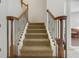 Elegant staircase with wood railings and neutral carpet at 148 Calliope St, Ocoee, FL 34761