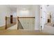 Upstairs hall with wooden railing and carpet flooring at 148 Calliope St, Ocoee, FL 34761