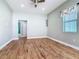 Bright bedroom with wood-look tile floor, ceiling fan, and window coverings at 1480 Battle St, Oviedo, FL 32765