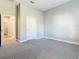 Spacious bedroom with grey carpet, a large closet, and an adjacent hallway at 1480 Battle St, Oviedo, FL 32765