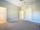 Primary bedroom with grey carpet and en-suite bathroom access at 1480 Battle St, Oviedo, FL 32765