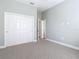 Spacious bedroom with neutral walls, carpet flooring, and double-door closet at 1480 Battle St, Oviedo, FL 32765