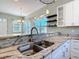 Modern kitchen with granite countertops, stainless steel sink, and white cabinets at 1480 Battle St, Oviedo, FL 32765