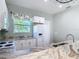 Modern kitchen with white cabinets, granite counters, and stainless steel appliances at 1480 Battle St, Oviedo, FL 32765