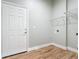 Bright laundry room with wood-look tile floor, white door, and wire shelving at 1480 Battle St, Oviedo, FL 32765